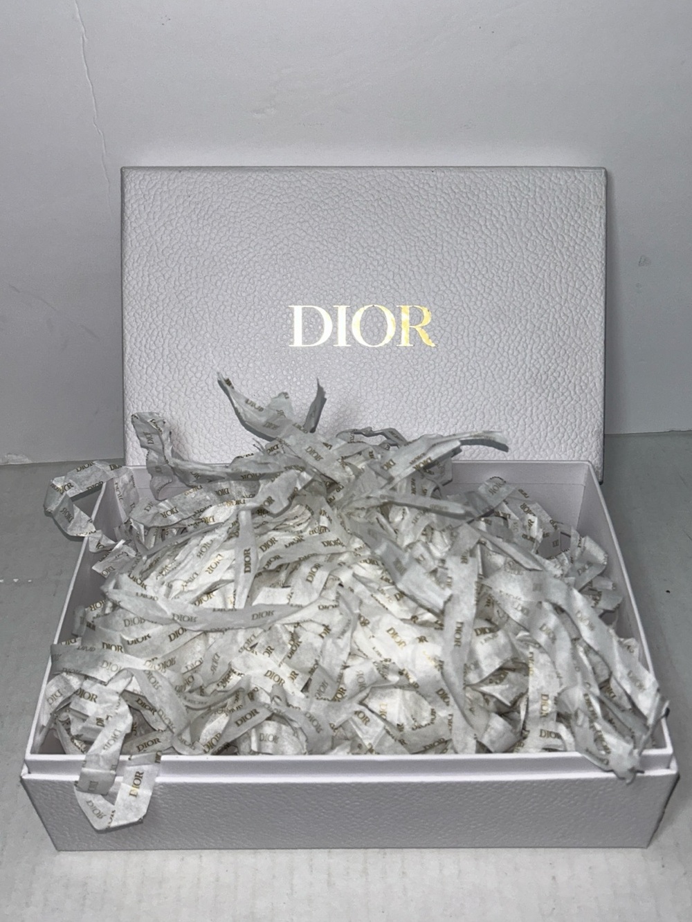 Dior box with branded shredded paper